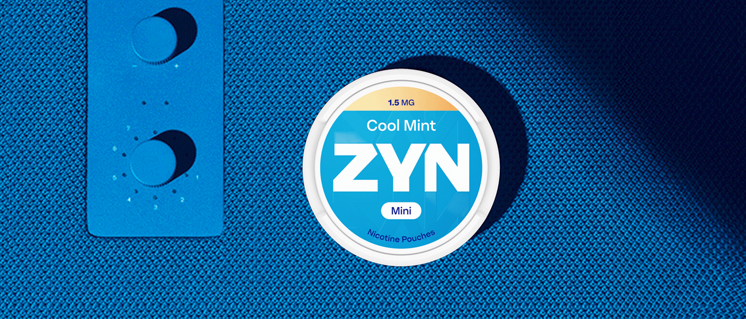 Woman wearing a blue sweater, listening to music while trying a ZYN nicotine pouch